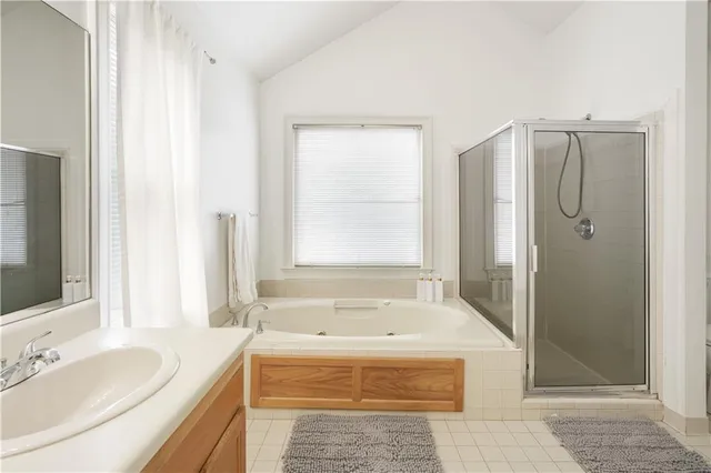 a bathroom with a tub a sink and a window