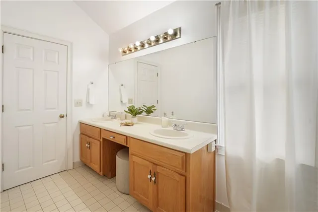 a bathroom with a tub sink and mirror