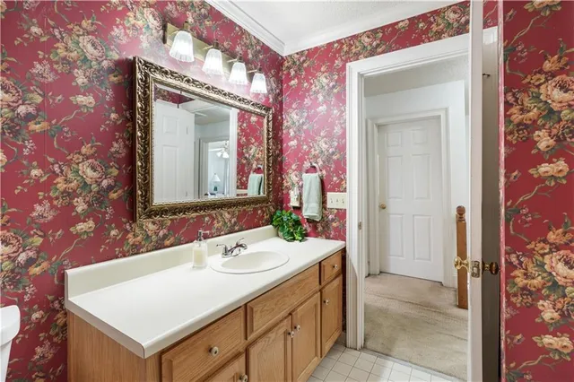 a bathroom with a sink vanity mirror and toilet