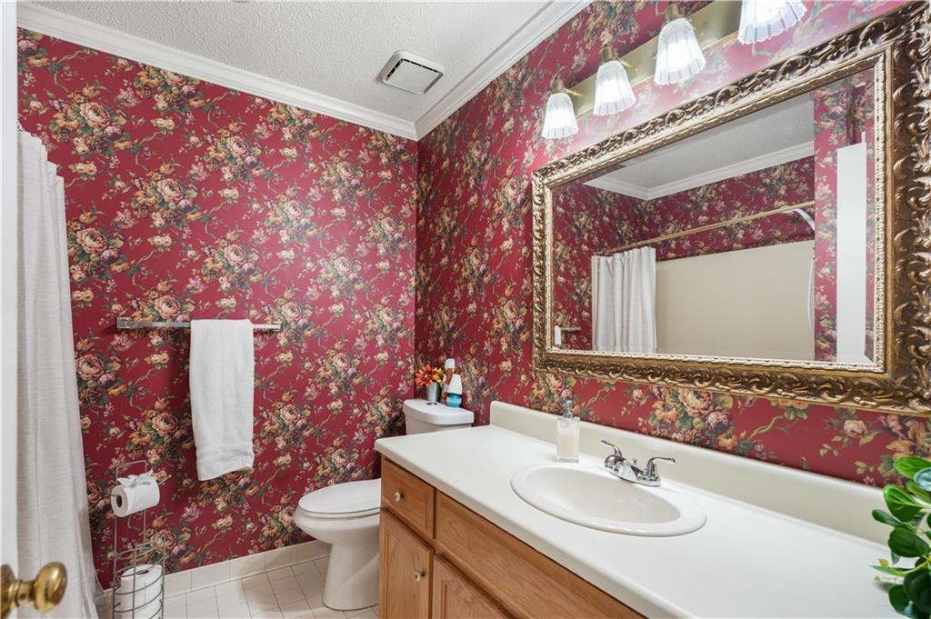 224 Rolling Oaks Drive Rome, GA 30165 - Photo 22 of 55 a bathroom with a sink vanity mirror and toilet