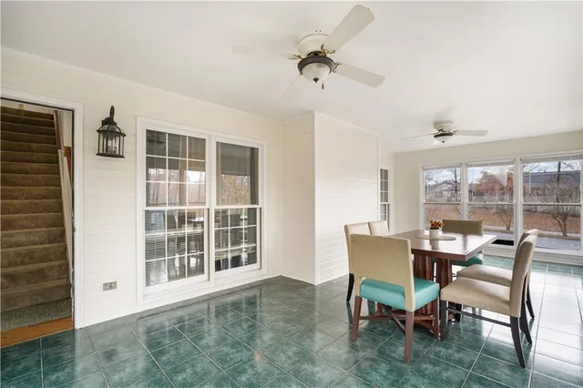 a dining room with furniture and front door