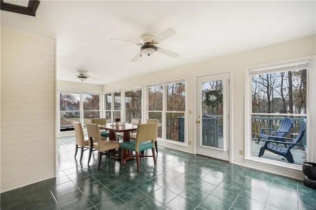 a view of a livingroom with wooden floor and furniture