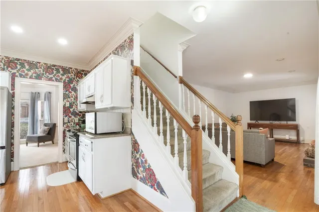 a kitchen with granite countertop a sink stainless steel appliances and cabinets