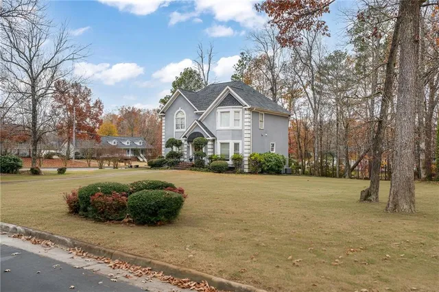 a view of a house with a yard covered in snow