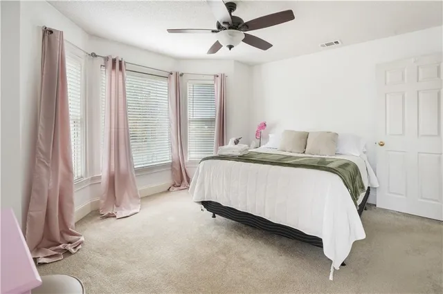 a bedroom with a bed dresser and a window