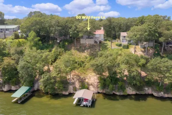 a living room with fireplace furniture and floor to ceiling windows