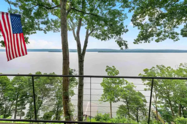 a living room with furniture a flat screen tv and a large window