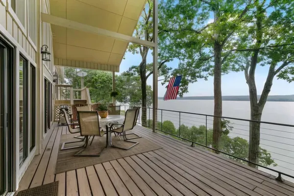 a living room with furniture and floor to ceiling windows