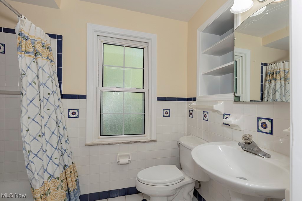 14711 South Woodland Road Cleveland, OH 44120 - Photo 22 of 31 The Main Hall Bathroom has been Updated with New Fixtures and Tile. The Bathtub has an Overhead Shower.