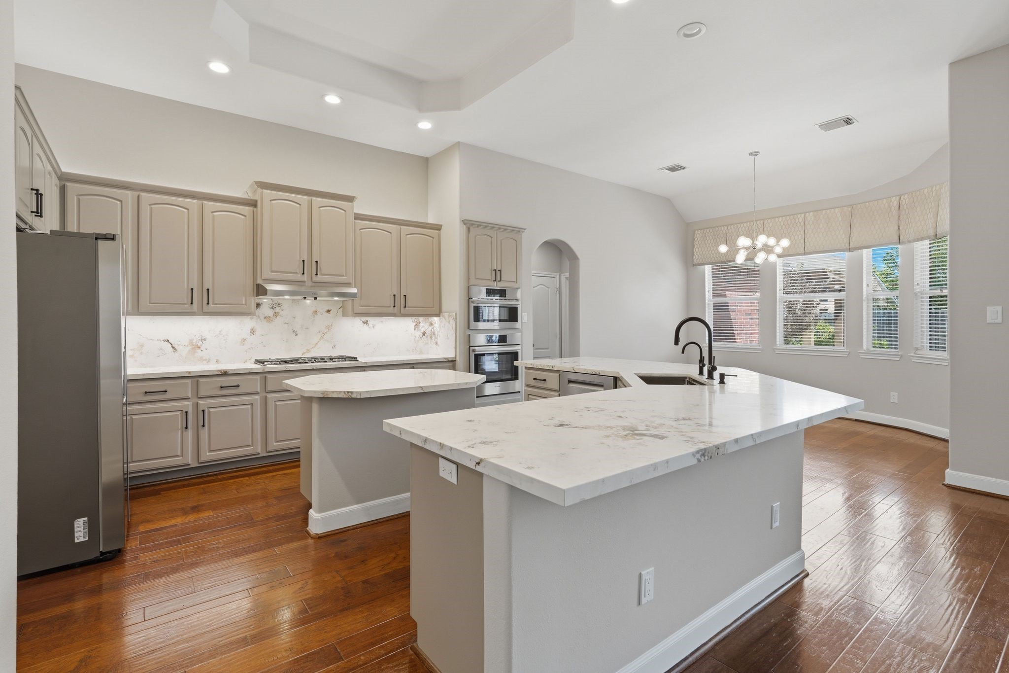 2118 Cias Trail Lane Spring, TX 77386 - Photo 12 of 46 FULLY UPDATED KITCHEN! Cabinets, Quartz countertops, all high end Bosch appliances come with the home, Farmhouse sink, Custom rollout storage in kitchen!