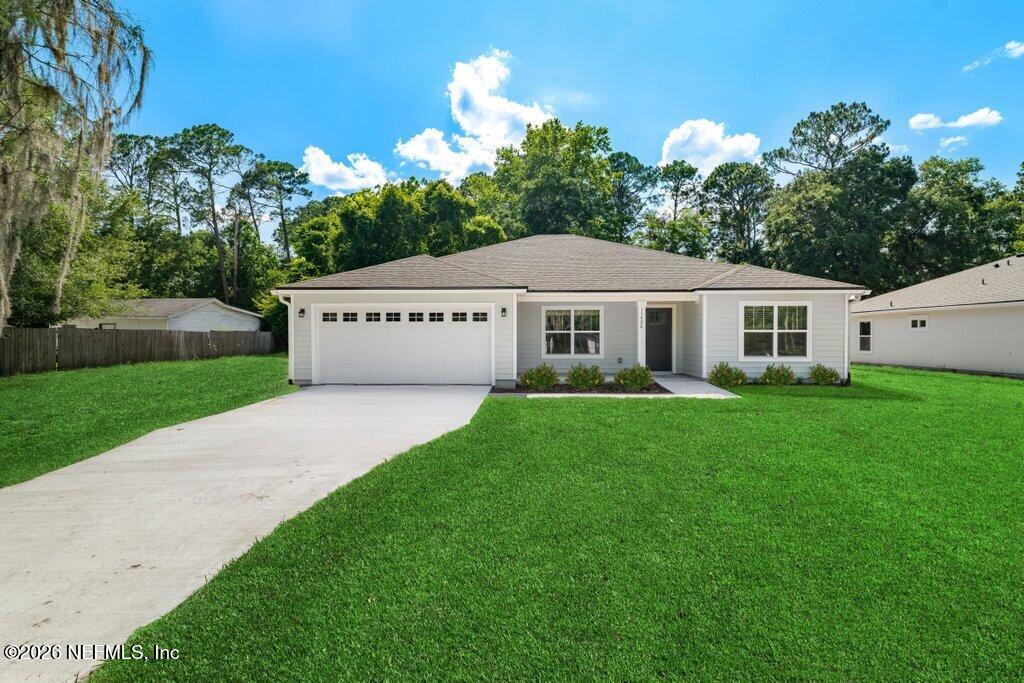 9680 Taylor Field Road Jacksonville, FL 32222 - Photo 1 of 27 a view of a white house with a big yard potted plants and large tree