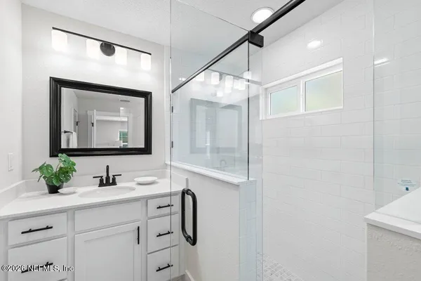 a bathroom with a sink vanity and mirror