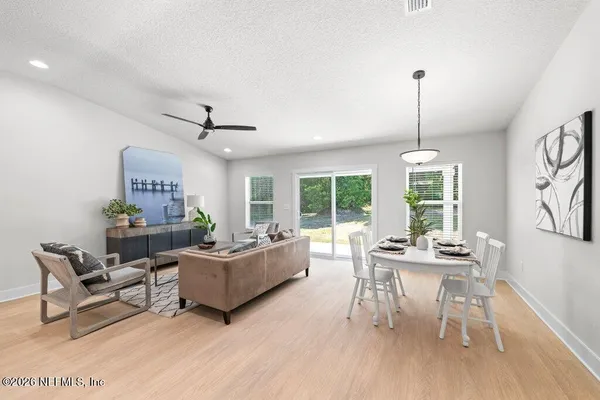 a living room with furniture and a wooden floor