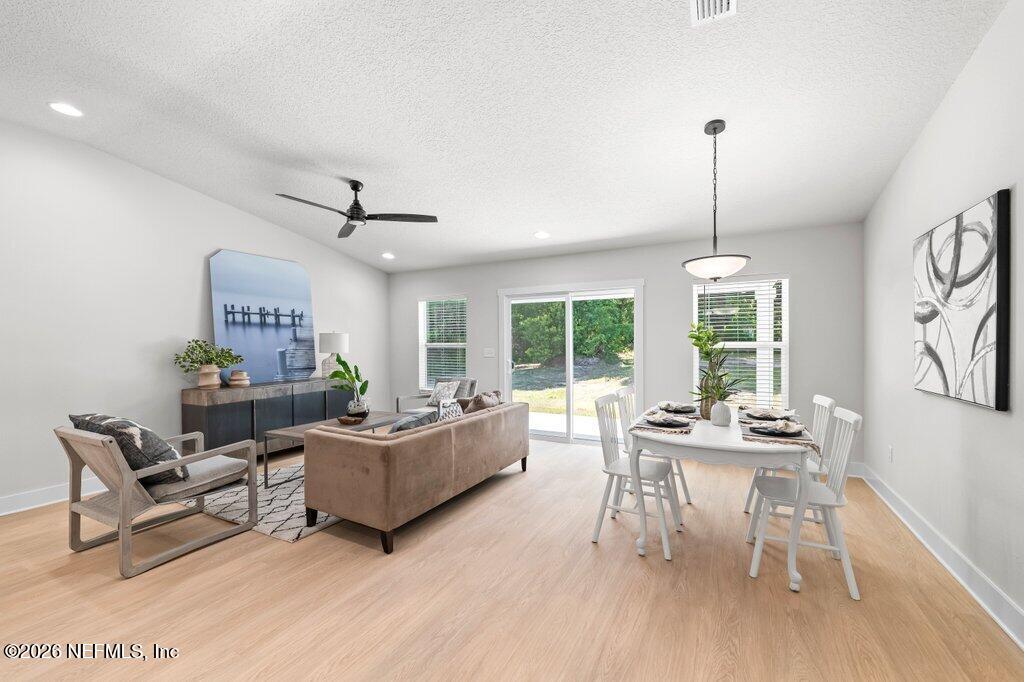 9680 Taylor Field Road Jacksonville, FL 32222 - Photo 17 of 27 a living room with furniture and a wooden floor