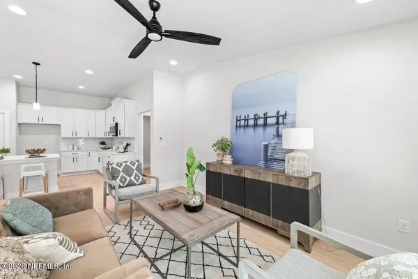 a living room with furniture and a wooden floor