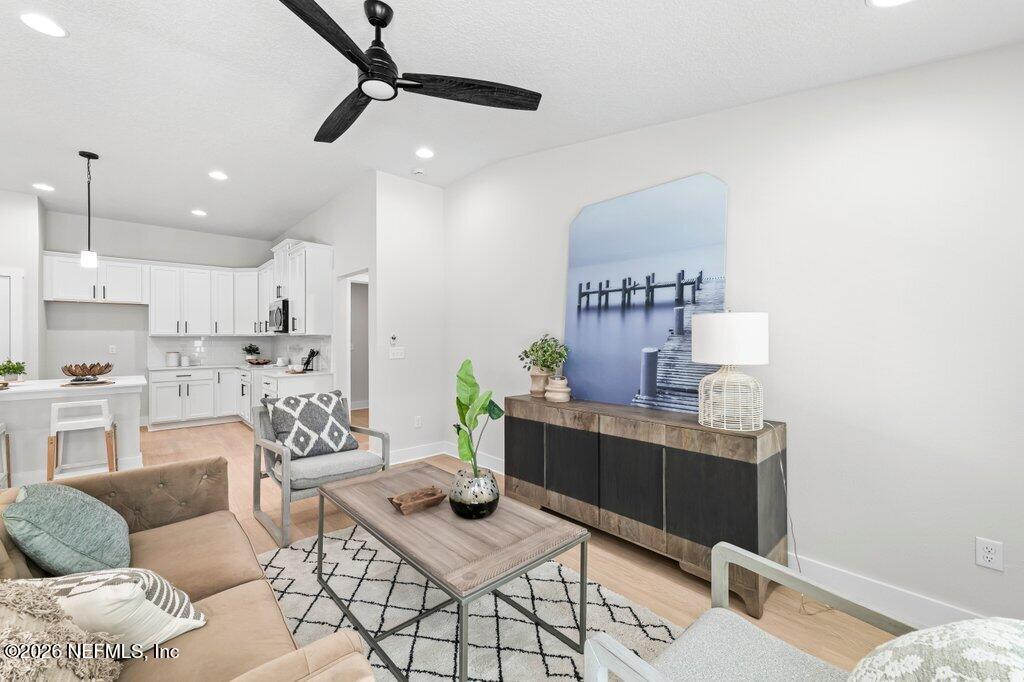 9680 Taylor Field Road Jacksonville, FL 32222 - Photo 19 of 27 a living room with furniture and a wooden floor