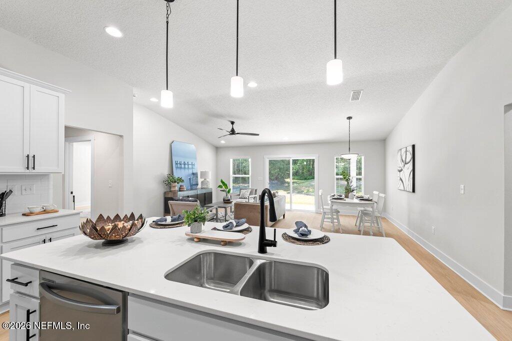 9680 Taylor Field Road Jacksonville, FL 32222 - Photo 2 of 27 a kitchen with counter top a sink appliances and cabinets