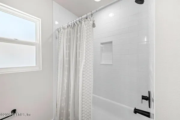 a bathroom with a shower and a tub