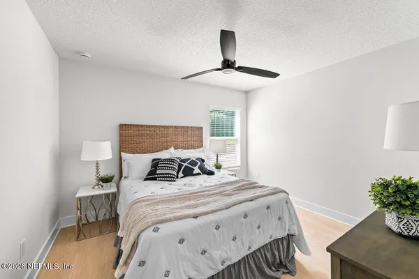 a bedroom with a bed and a potted plant
