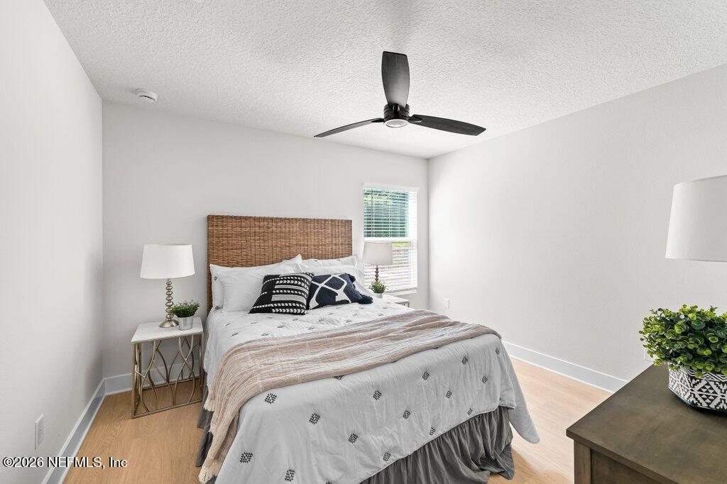 9680 Taylor Field Road Jacksonville, FL 32222 - Photo 24 of 27 a bedroom with a bed and a potted plant