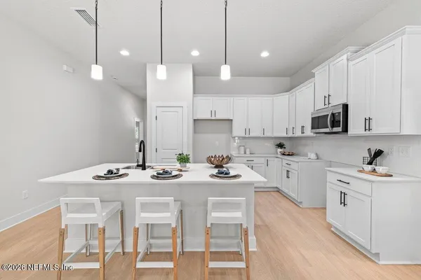 a kitchen with stainless steel appliances kitchen island granite countertop a sink and cabinets
