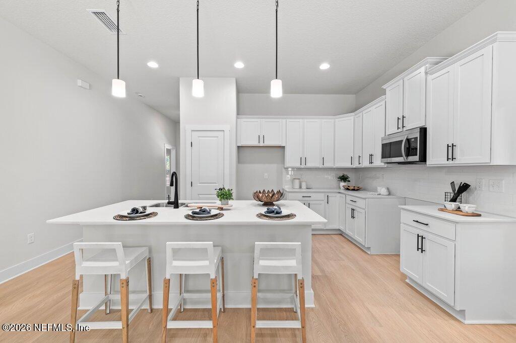 9680 Taylor Field Road Jacksonville, FL 32222 - Photo 5 of 27 a kitchen with stainless steel appliances kitchen island granite countertop a sink and cabinets