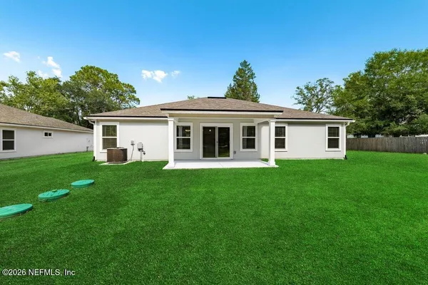 a front view of house with a garden