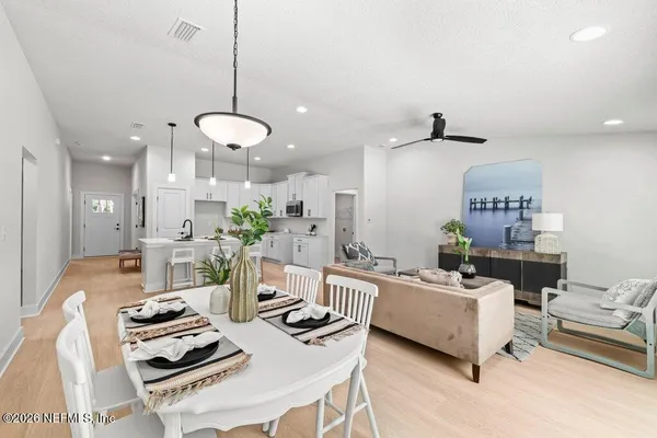a living room with furniture and kitchen view