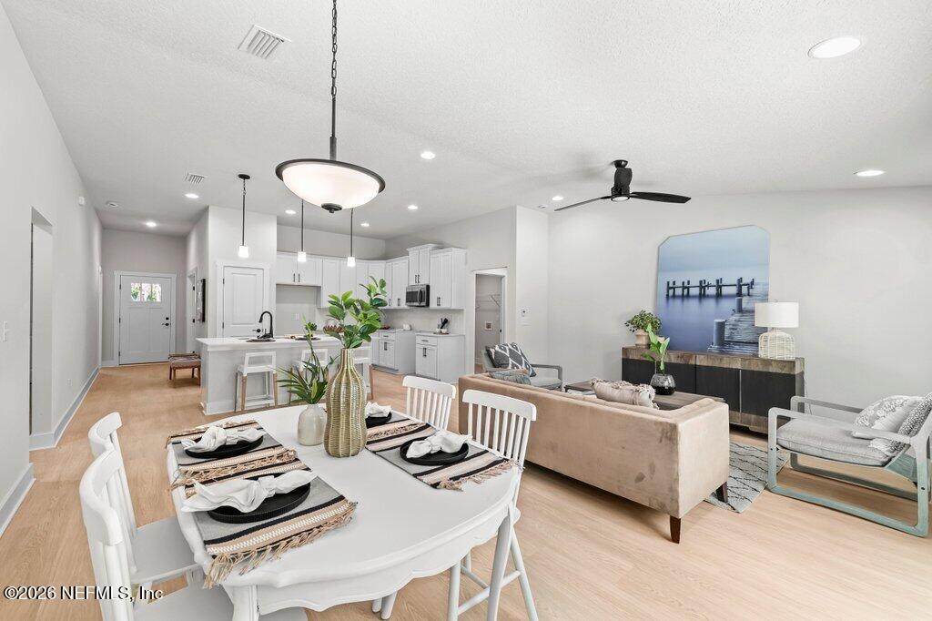 9680 Taylor Field Road Jacksonville, FL 32222 - Photo 8 of 27 a living room with furniture and kitchen view