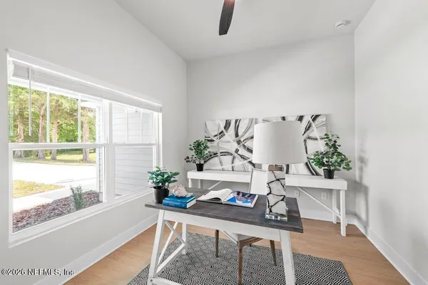 a living room with furniture and a potted plant