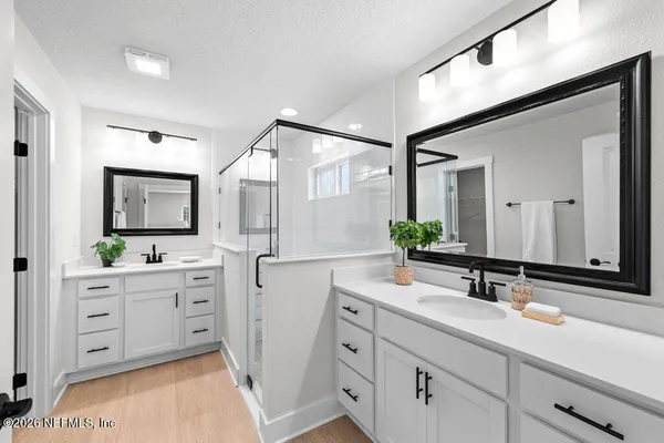 a bathroom with a double vanity sink mirror and cabinet