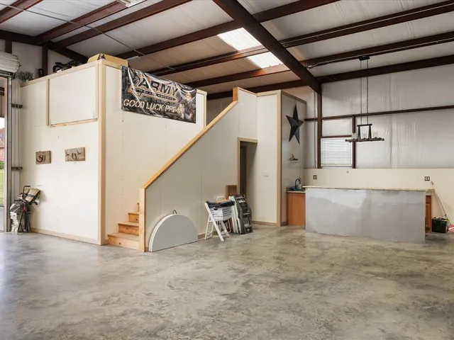 a view of a patio with table and chairs under an umbrella