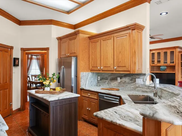 a kitchen with a stove a sink and a refrigerator