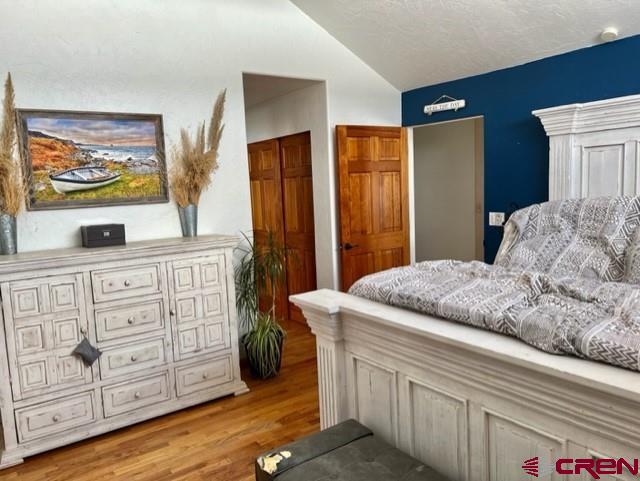 64130 Peach Valley Road Crawford, CO 81415 - Photo 14 of 33 a bedroom with a bed and a dresser