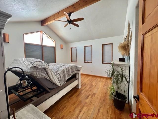 64130 Peach Valley Road Crawford, CO 81415 - Photo 16 of 33 a bedroom with a bed and wooden floor