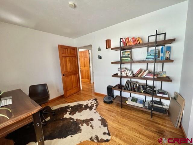 64130 Peach Valley Road Crawford, CO 81415 - Photo 21 of 33 a bedroom with furniture and a window