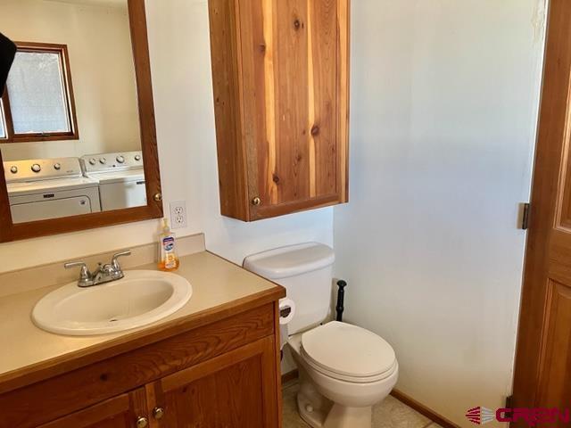 64130 Peach Valley Road Crawford, CO 81415 - Photo 23 of 33 a bathroom with a toilet sink and mirror