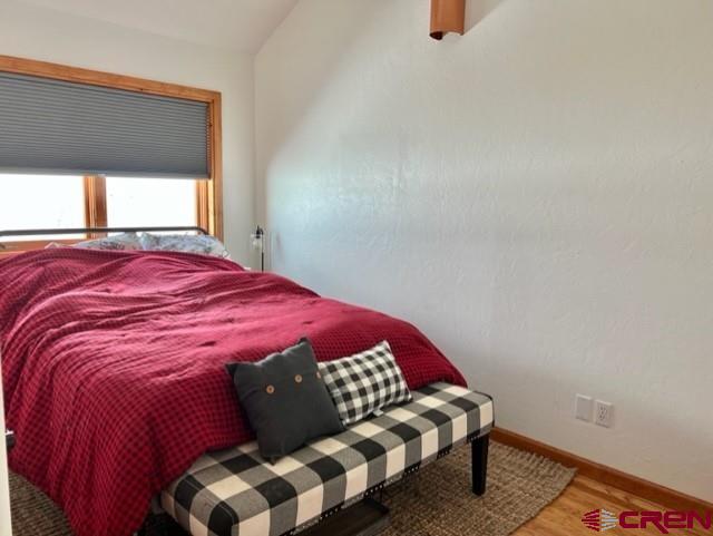 64130 Peach Valley Road Crawford, CO 81415 - Photo 25 of 33 a bedroom with a bed and window