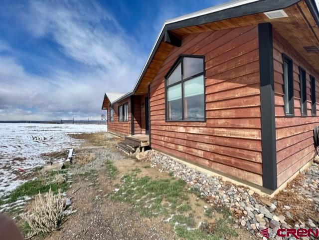 64130 Peach Valley Road Crawford, CO 81415 - Photo 29 of 33 a backyard of a house with barbeque oven table and chairs