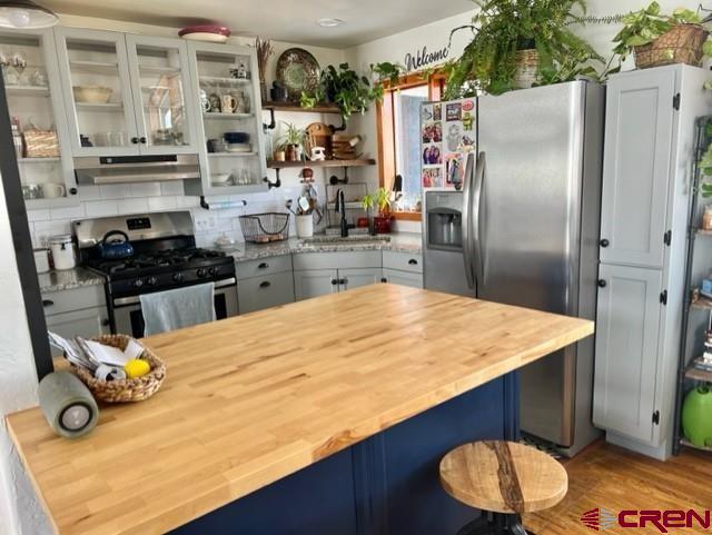 64130 Peach Valley Road Crawford, CO 81415 - Photo 5 of 33 a kitchen with stainless steel appliances granite countertop a refrigerator a stove and a sink