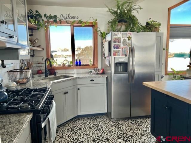 64130 Peach Valley Road Crawford, CO 81415 - Photo 6 of 33 a kitchen with stainless steel appliances granite countertop a refrigerator and a sink