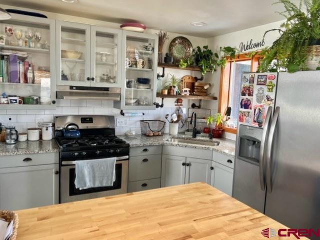 64130 Peach Valley Road Crawford, CO 81415 - Photo 8 of 33 a kitchen with stainless steel appliances granite countertop a sink stove and refrigerator