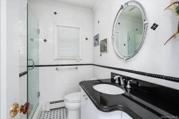 a bathroom with a toilet a sink and mirror