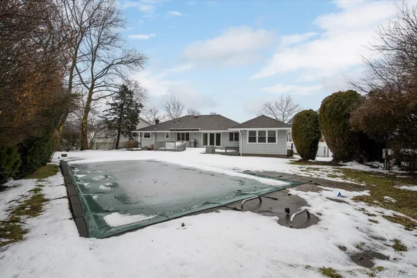 a view of a house with a snow in the background