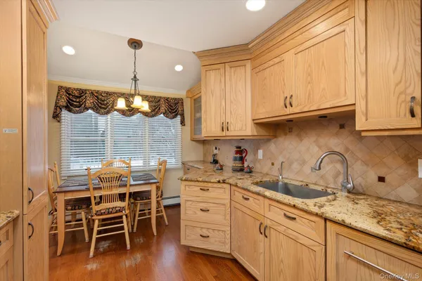 a kitchen with stainless steel appliances granite countertop a sink a stove and cabinets
