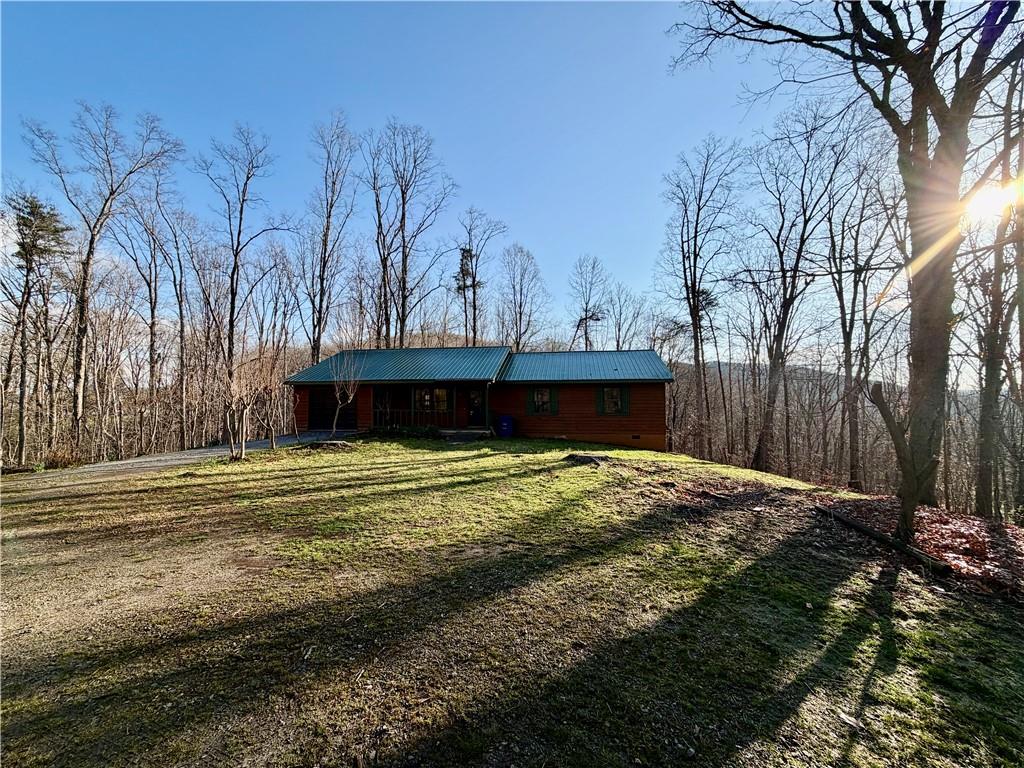 1565 Shoal Creek Road Cleveland, GA 30528 - Photo 19 of 38 a view of a backyard with large trees