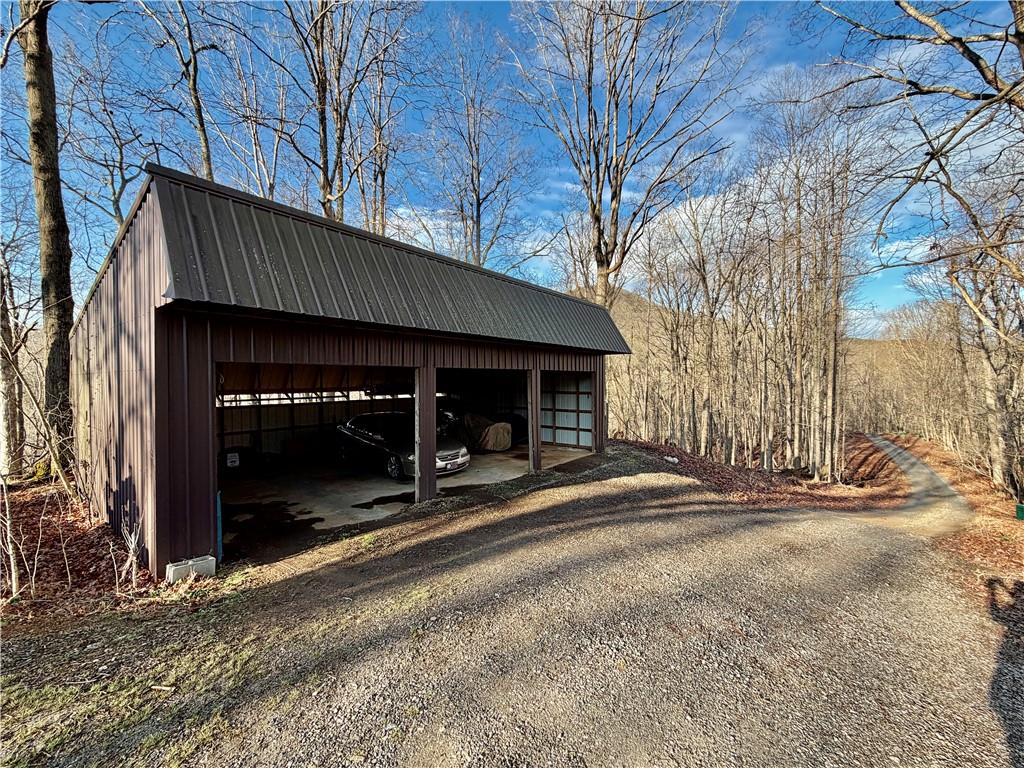1565 Shoal Creek Road Cleveland, GA 30528 - Photo 35 of 38 a view of a house with large trees and wooden fence