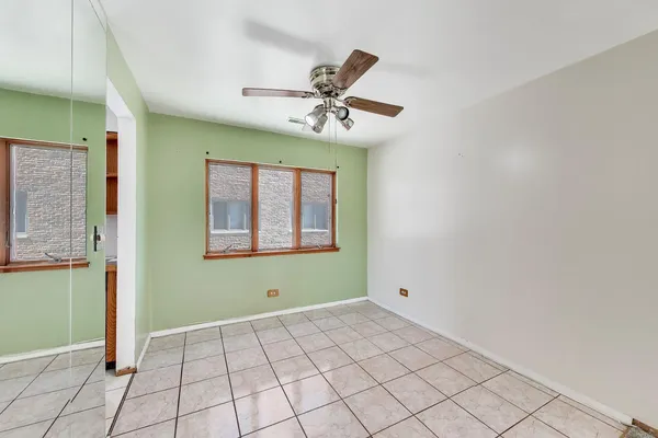a view of an empty room with window and cabinet
