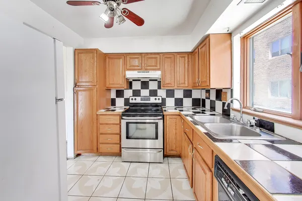 a kitchen with a sink stove and cabinets
