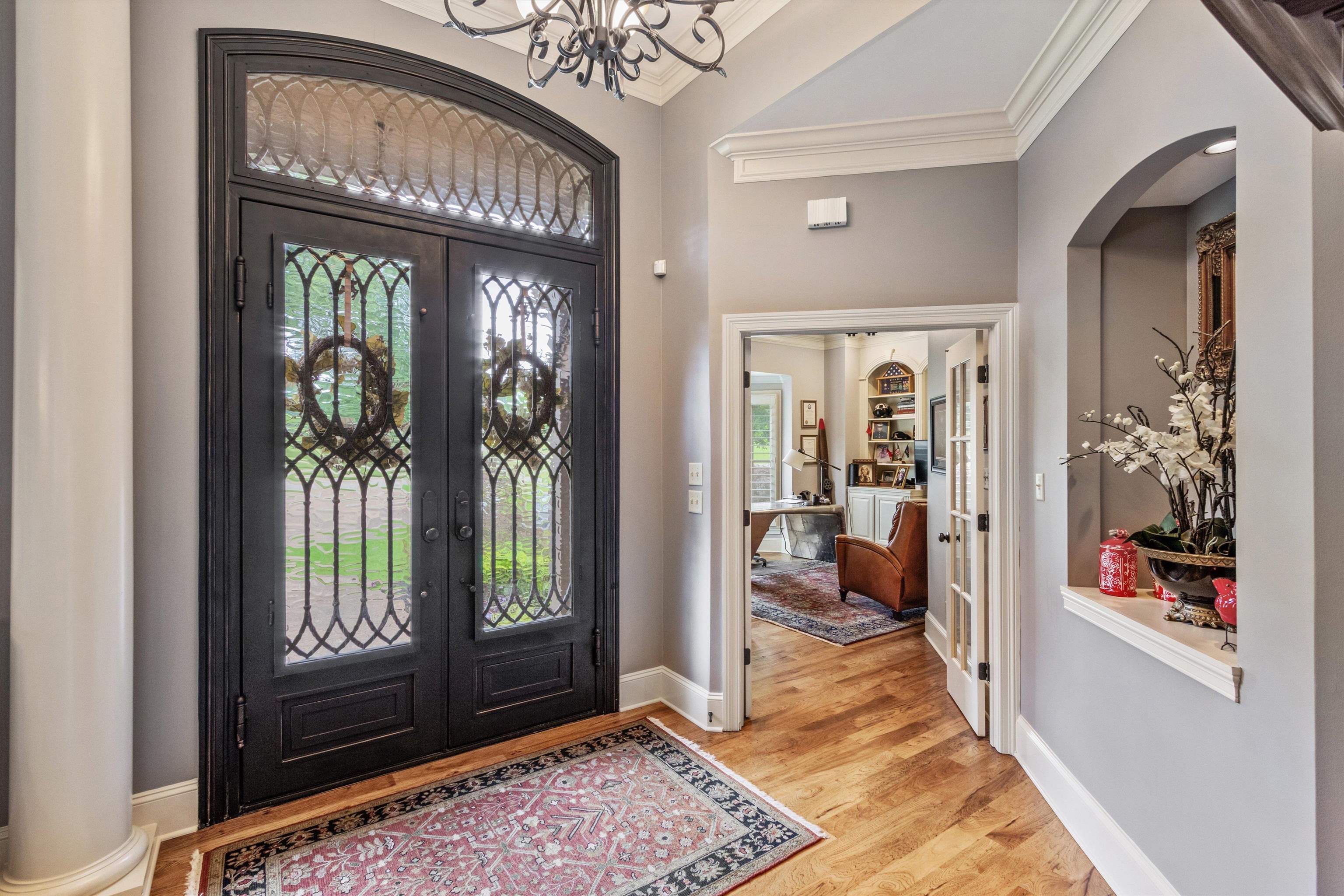 150 Ridgecrest Drive Arlington, TN 38002 - Photo 6 of 40 Grand entryway featuring custom iron double doors with an arched transom, wood-finish flooring, and crown molding